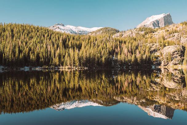 Bear Lake and reflection with mountains in snow around at autumn. Rocky Mountain National Park in Colorado, USA.  - Photo, image