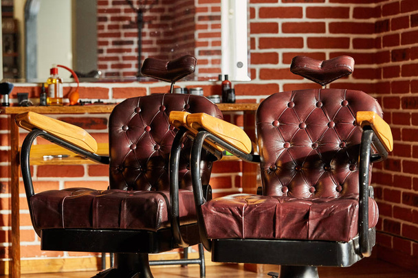 Retro leather chair barber shop in vintage style. Barbershop theme. - 写真・画像