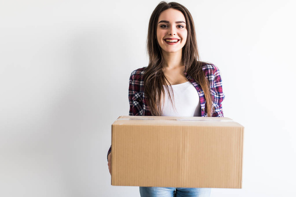 Woman carrying moving boxes. Young woman moving house to new home holding cardboard boxes - Photo, Image