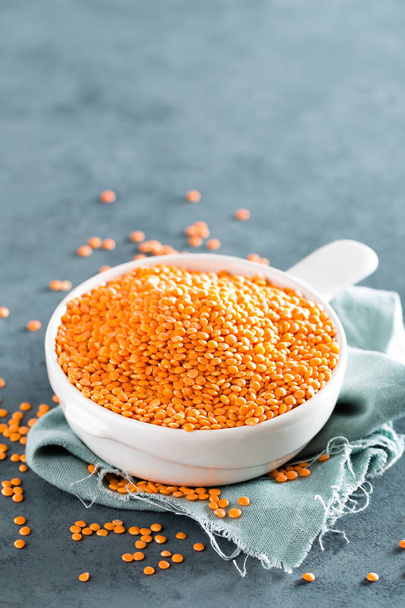 Raw lentil in bowl on table. Fresh lentils. Vegetarian food - Фото, зображення
