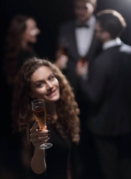 happy young woman raising a glass of champagne - Фото, зображення