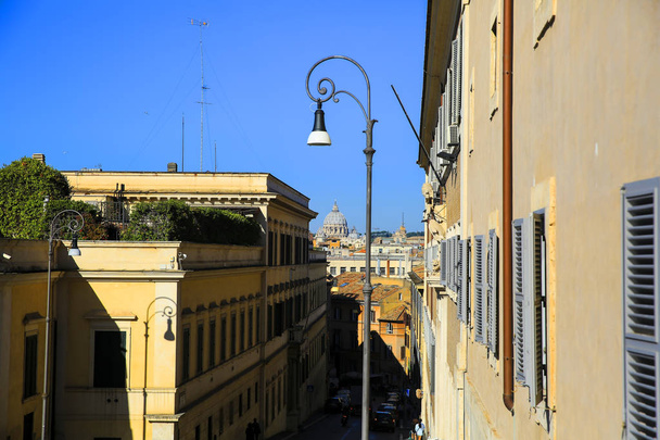 Roman street and Basilica di San Pietro in Rome, Italy - Fotó, kép