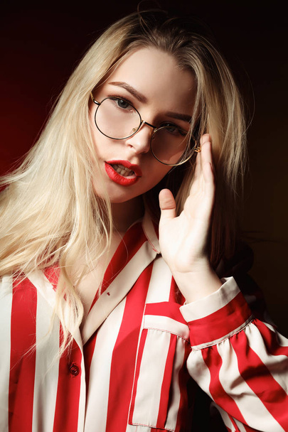 Glamor blonde woman with red lips wearing glasses, posing with c - Fotoğraf, Görsel
