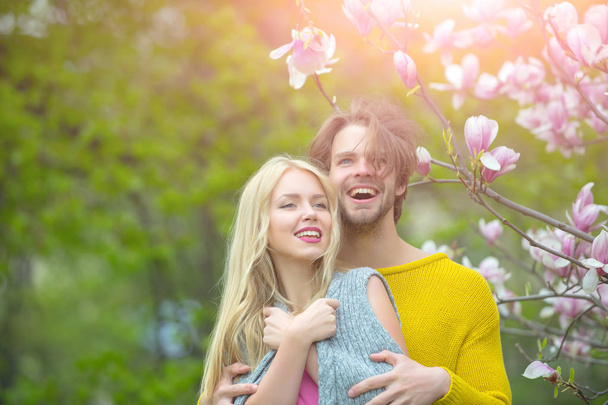 man and woman, couple in love in spring magnolia flowers - Φωτογραφία, εικόνα