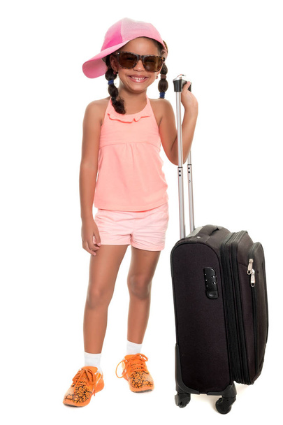 Cute african american girl carrying a travel suitcase - Fotografie, Obrázek