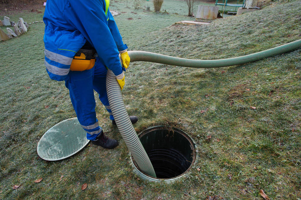 Emptying household septic tank. Cleaning sludge from septic system. - Photo, Image