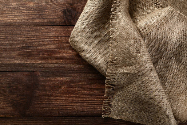 Sackcloth texture on brown wooden table - Valokuva, kuva