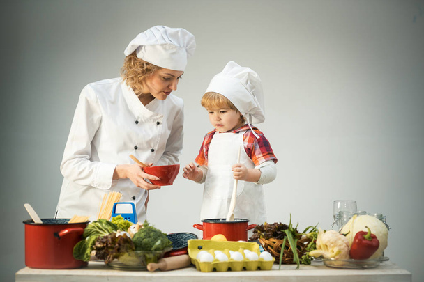 Chef and assistant near kitchen equipment and food products. - Foto, Imagem