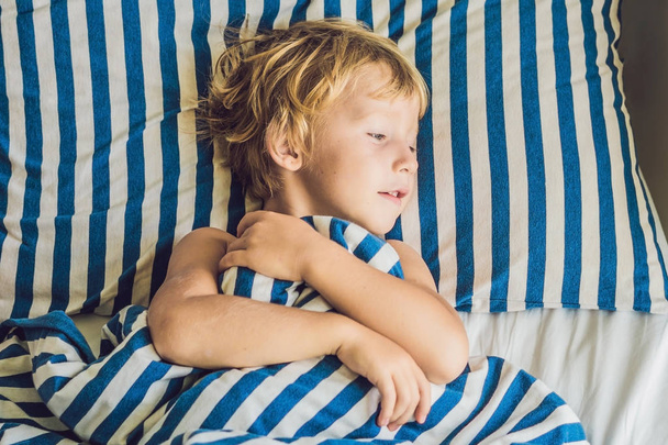 Cute little boy waking up in bed. Children sleep concept - Foto, Imagem