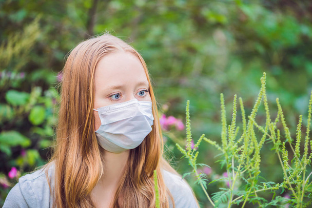 Young woman in a medical mask because of an allergy to ragweed. - Photo, Image