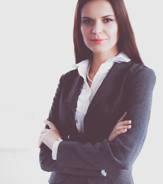 Attractive young businesswoman standing near desk in the office - Foto, immagini