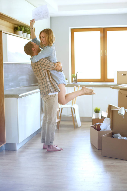 Portrait of young couple moving in new home. Young couple - Foto, Imagem