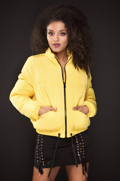 Girl with glamour makeup posing in yellow jacket. - Foto, Imagem