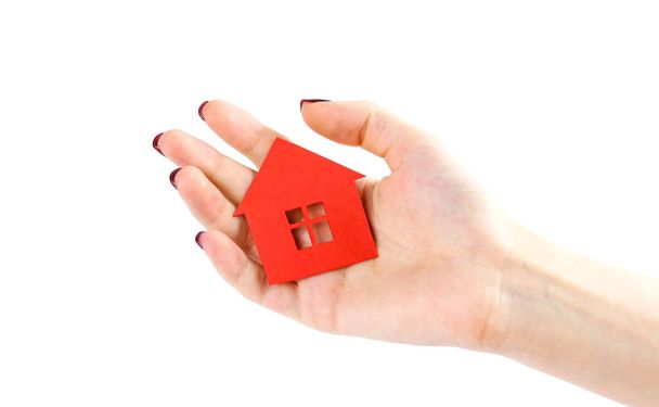 The hand holds the red house. House in hands. Close up. Isolated - Foto, Bild