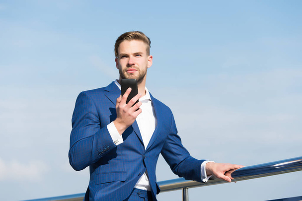 Businessman in business suit with mobile phone, new technology - Fotó, kép