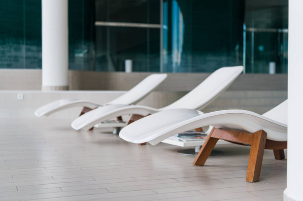 moderne Liegestühle im Luxushotel. privater Pool zum Entspannen, mit schönem Interieur. - Foto, Bild