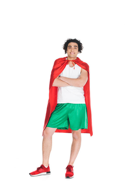 Young thin sprotsman standing in red cape isolated onn white - Photo, Image
