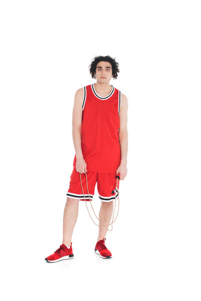 Young skinny sportsman standing with jump rope in hands isolated on white - Φωτογραφία, εικόνα