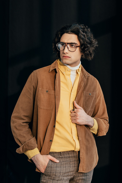 Young male fashion model in eyeglasses isolated on black - Zdjęcie, obraz