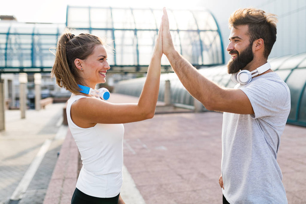 Portrait of young attractive happy fitness couple together outside - Photo, image