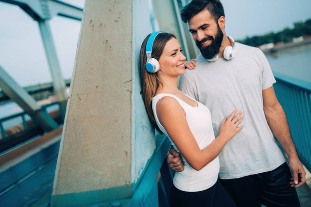 Portrait of young attractive happy fitness couple together outside - Photo, Image