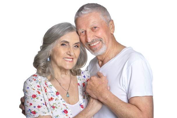 Portrait of hugging senior couple isolated on white background - 写真・画像
