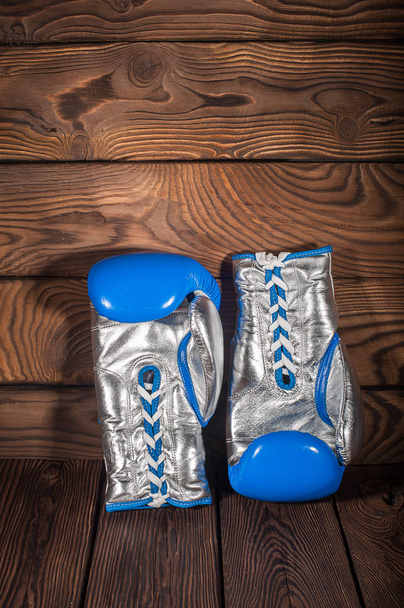 Boxing gloves on dark brown cracked wooden background - Photo, image