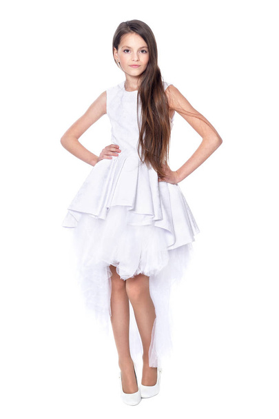 Happy little girl in white dress posing isolated on white background - Foto, Imagem