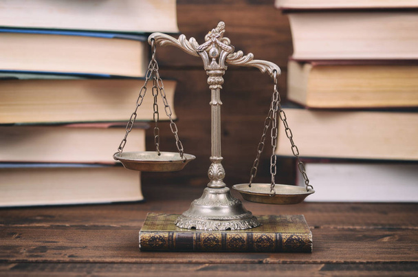  Scales of Justice and law books on a wooden background. - Foto, Imagem