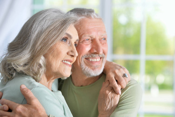 portrait of a happy senior couple hugging  at home - Foto, afbeelding
