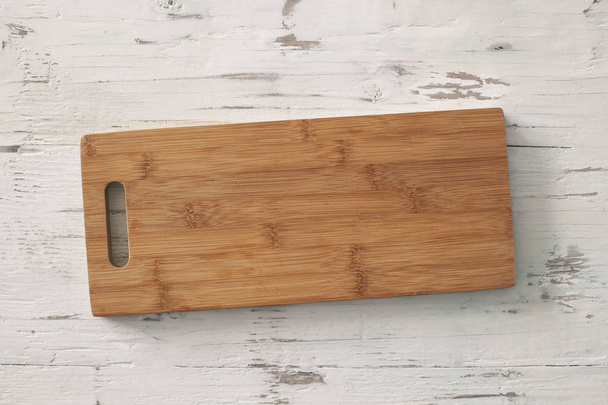 Wooden chopping board on wooden background - Foto, Imagen