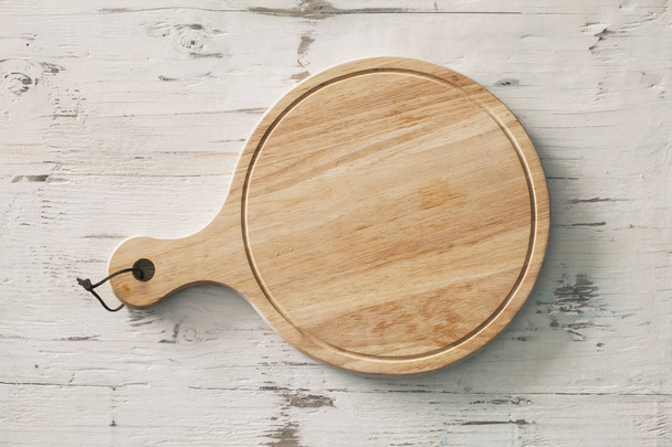 Wooden chopping board on wooden background - Foto, Imagen