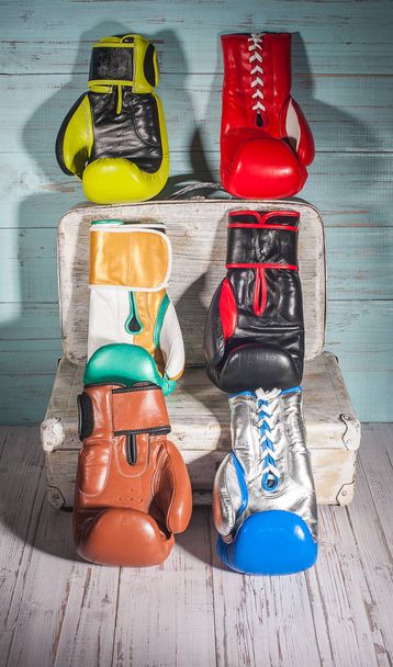 Boxing gloves on blue and white cracked wooden background - Photo, image