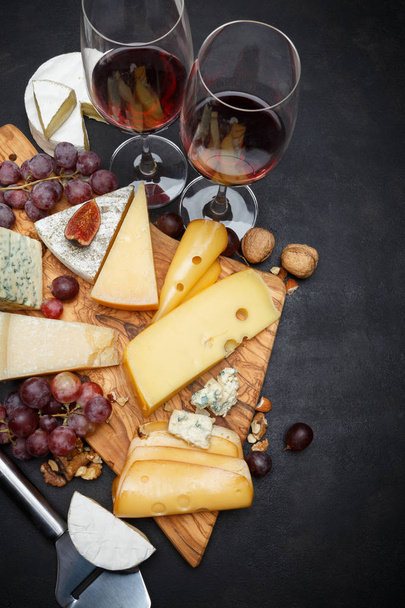 Wine and Various types of cheese - parmesan, brie, roquefort, cheddar - Photo, Image