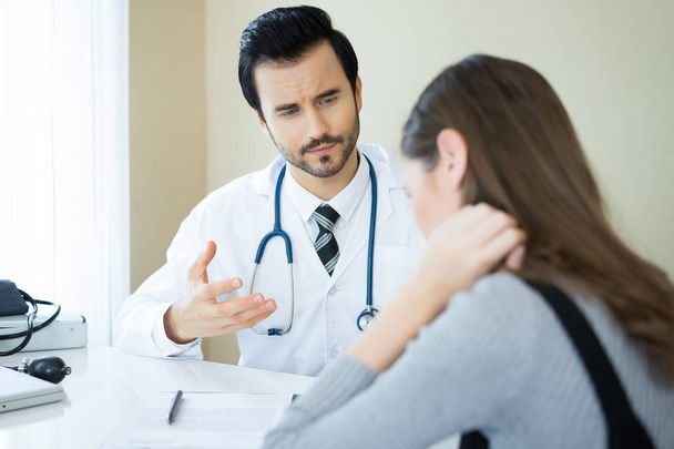Serious doctor explaining diagnosis to her female patient in med - Photo, image