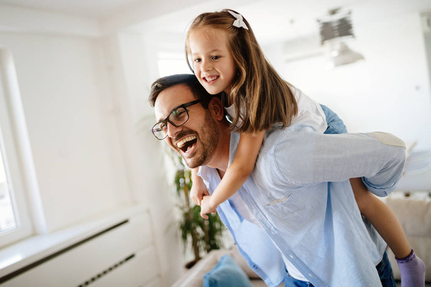 Portrait of father and daughter playing at home together - Photo, Image