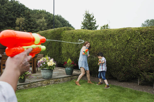 Family Water Fight in the Garden - Photo, Image