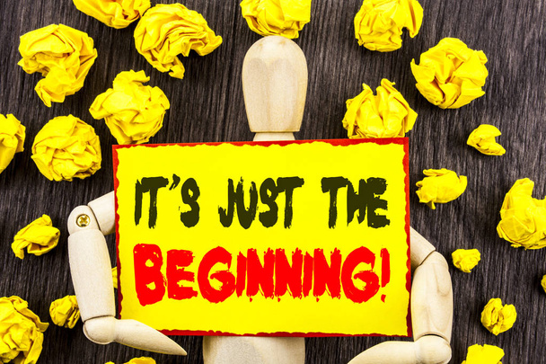 Announcement text showing It Is Just The Beginning. Concept meaning Goal Success Plan For New Dream Life Career written on Sticky Note Holding By Sculpture on the wooden background - Photo, Image