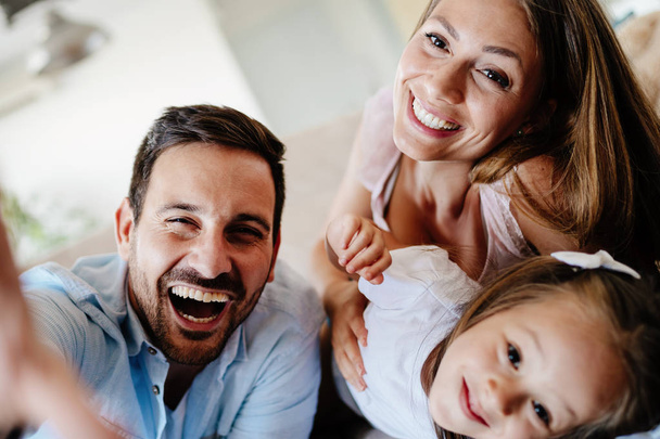 Happy family taking group selfie at their home - Photo, image