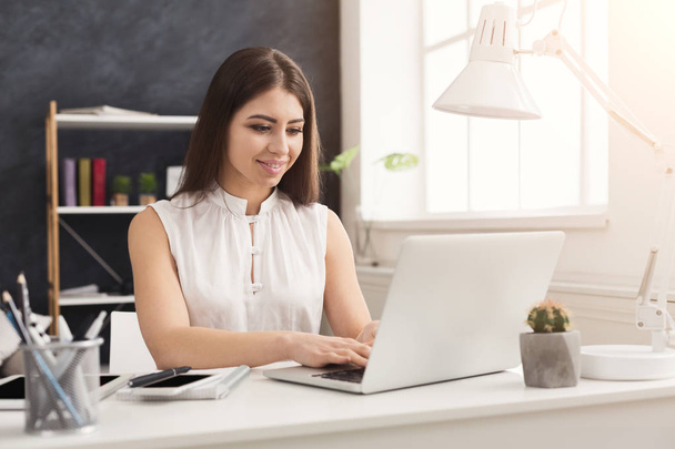 Young successful woman working on laptop - Photo, Image