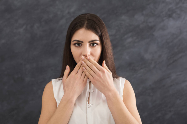 Scared woman covering mouth with hands - Photo, Image