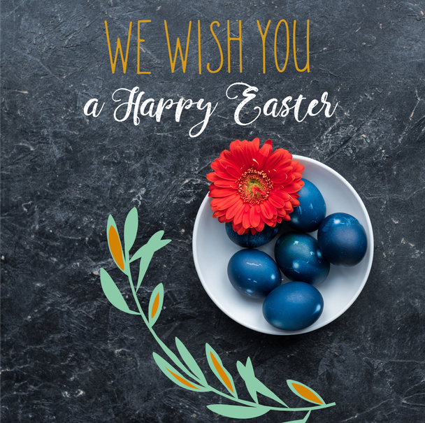 Painted chicken eggs on plate with happy easter lettering on dark background - Photo, Image