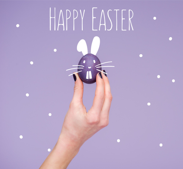 Easter egg in female hand with happy easter lettering - Photo, image