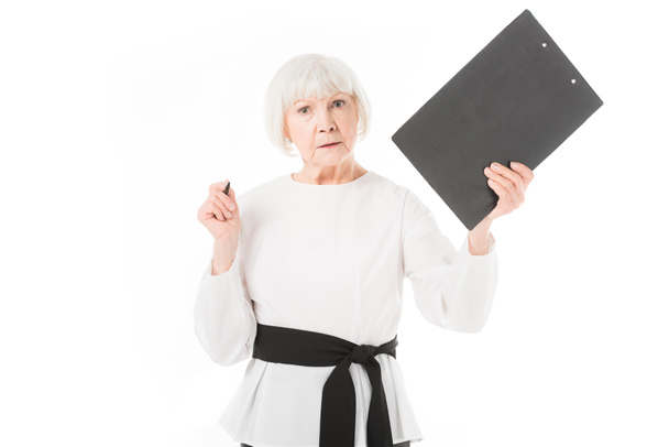 Serious senior businesswoman with clipboard and pen isolated on white - Photo, Image
