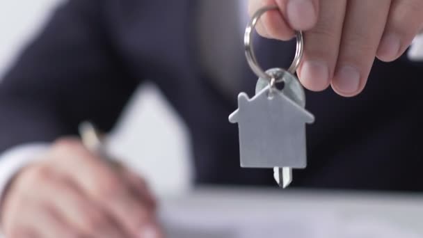 Menedżer nieruchomości dawanie klucz od wymarzonego domu kupującemu, podpisanie umowy na wynajem - Materiał filmowy, wideo
