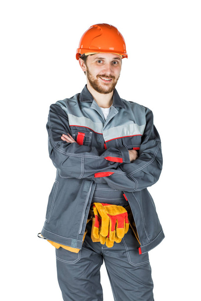 Smiling young builder, looking at camera. Repair and construction. Isolated over white background - Valokuva, kuva