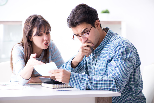 Young couple looking at family finance papers - Photo, Image