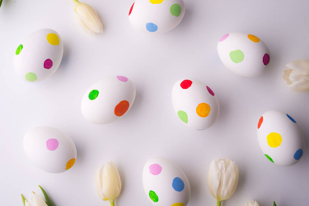 Flowers and dotty eggs on a white background. - 写真・画像