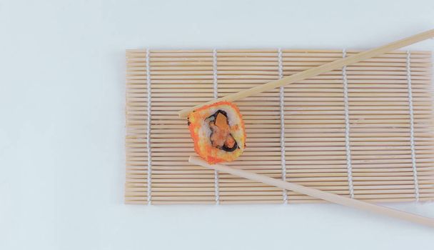 large sushi and chopsticks .isolated on a light - Photo, image