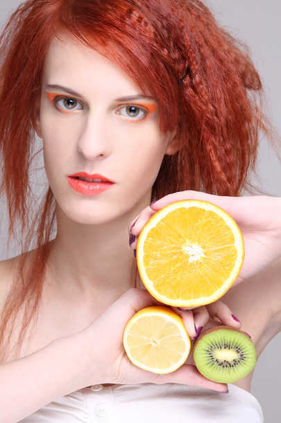 redhaired woman with orange, lemon and kiwi - Photo, Image